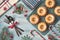 Mini bundt ring cakes with icing sugar on light background with fir twigs, berries and candy canes