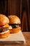 Mini burger on a stand close-up. Children fast food in a restaurant or cafe. Macro photo of burger ingredients with meat and