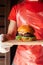 Mini burger on a stand close-up. Children fast food in a restaurant or cafe. Macro photo of burger ingredients with meat and