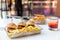 Mini burgers with french fries and a cocktail served at the bar, finger food, closeup