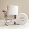 Mini cart, trolley shopping witch rolls of toilet paper. Concept of problem with consumer essential goods, hygiene