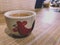 Mini Ceramic tea cup on wooden table.