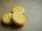 Mini cheese sandwich crackers on brown background.