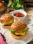 Mini cheeseburgers sliders with ground beef, cheddar, lettuce an