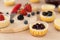 Mini cheesecake decorated with blueberry, blackberry and strawberry