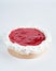 Mini cheesecake with red fruits jam topping on recycle Mini Wooden Baking Mold, white background, copy space, selective focus