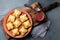 Mini chilean empanadas on clay plate with typical chilean drink vino con harina - red wine with toasted flour