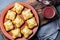 Mini chilean empanadas on clay plate with typical chilean drink vino con harina - red wine with toasted flour