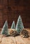 Mini christmas tree and pine cone wood on rustic wooden table an