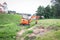 A mini crawler excavator is dripping a trench for laying communications.