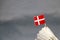 Mini Denmark flag stick on the white shuttlecock on the grey background