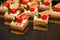 Mini desserts on catering buffet black tablecloth.