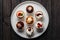 Mini desserts elegantly presented on pristine white plate, irresistible delights