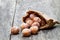 Mini doughnuts in paper bag on rustic wooden table