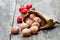 Mini doughnuts stuffed with strawberry jam in paper bag on rust