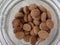 Mini Dutch spiced cookies inside a glass jar