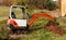 Mini excavator on a building site. Excavation work. The excavator works in the garden.