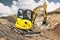 Mini excavator at the construction site. Compact construction equipment for earthworks. An indispensable assistant for earthworks