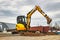 Mini excavator at the construction site. Compact construction equipment for earthworks. An indispensable assistant for earthworks