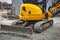 mini excavator digs a trench at a construction site. Laying of underground sewer pipes and communications during construction.