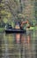 Mini excavator, on a floating pontoon, clearing the River Wey, Surrey.