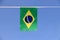 Mini fabric rail flag of Brazil, a blue disc depicting a starry sky with the national motto Order and Progress.