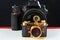 Mini gift golden camera on background of big one