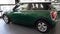 MINI green hatchback in showroom vehicle dealership