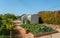 Mini-greenhouse made of plastic in garden, for growing seedlings of vegetables at home, in early spring installed in