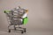 A mini grocery cart filled with medicines on a white background. Trolley with pills and nasal drops. Basket on a white background