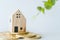 Mini house model on gold coin with clean white copyspace background. Business invest property saving