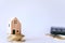 Mini house model on gold coin with clean white copyspace background. Business invest property saving