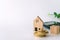 Mini house model on gold coin with clean white copyspace background. Business invest property saving