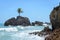 Mini island with a single coconut tree surrounded by sea water and some rock formations in a paradisiacal scenery, very beautiful