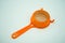 Mini kitchen sieve with orange plastic handle