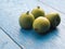 Mini kiwis Actinidia arguta on an stoneware plate on a rustic kitchen table