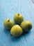 Mini kiwis Actinidia arguta on an stoneware plate on a rustic kitchen table