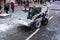 Mini loader removes snow from the street editorial