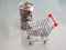 Mini model cart type in the supermarket and Many coins are in clear plastic cans out of focus background