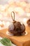 Mini mousse pastry dessert with chocolate glazed. Garland lamps bokeh on background. Modern european cake. French