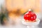Mini mousse pastry dessert covered with red glazed on garland lamps bokeh background. Modern european cake. French