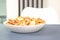 Mini pancakes cereal in white bowl for breakfast in modern kitchen interior - new trendy food, activities during coronavirus