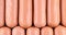 Mini sausage video background. Food background. Mini hotdogs or cocktails sausage. Top view video of Mini sausage