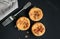 Mini savory quiches on black table with fork
