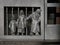 Mini sculpture of a historic family with a child at the bottom of a metal front door