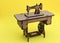 Mini sewing machine, made of wood, on yellow background