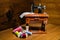 Mini sewing machine on a wooden table with small colorful threads next to it