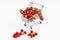 Mini shopping cart full with cherry tomatos on white background