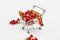 Mini shopping cart full with cherry tomatos on white background