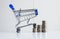 Mini shopping cart with step of coins stacks,Finance and money shopping concept